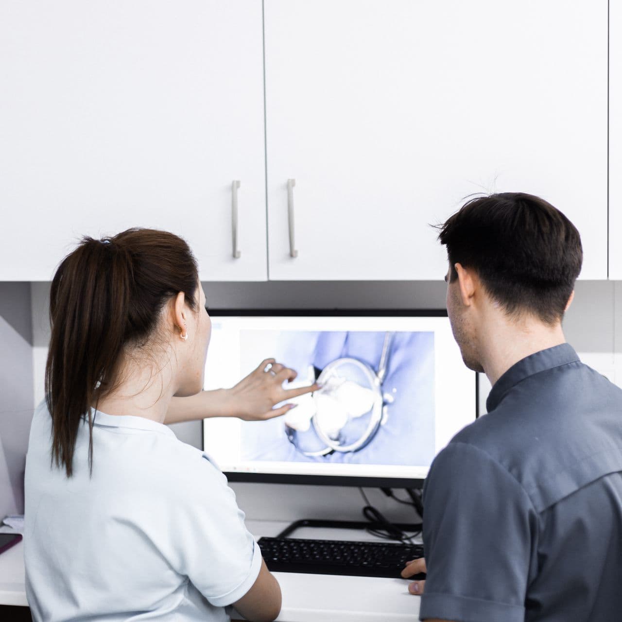 Clinicians reviewing a dental case together on screen